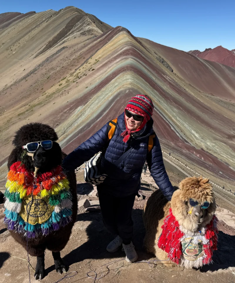 Tourist with two alpacas on Rainbow Mountain